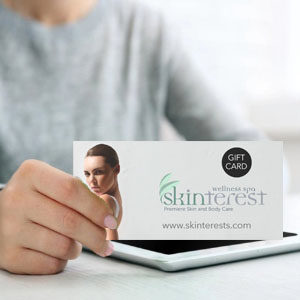 Hand holding a Sk gift card.